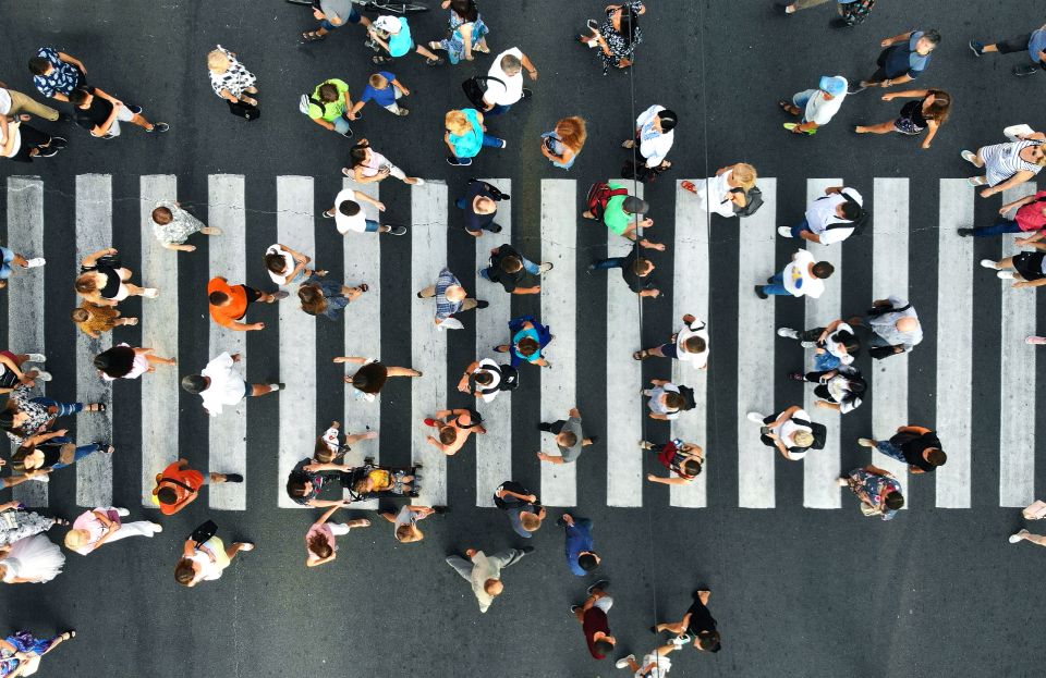 Overhead view of busy crosswalk with more than 20 people in it